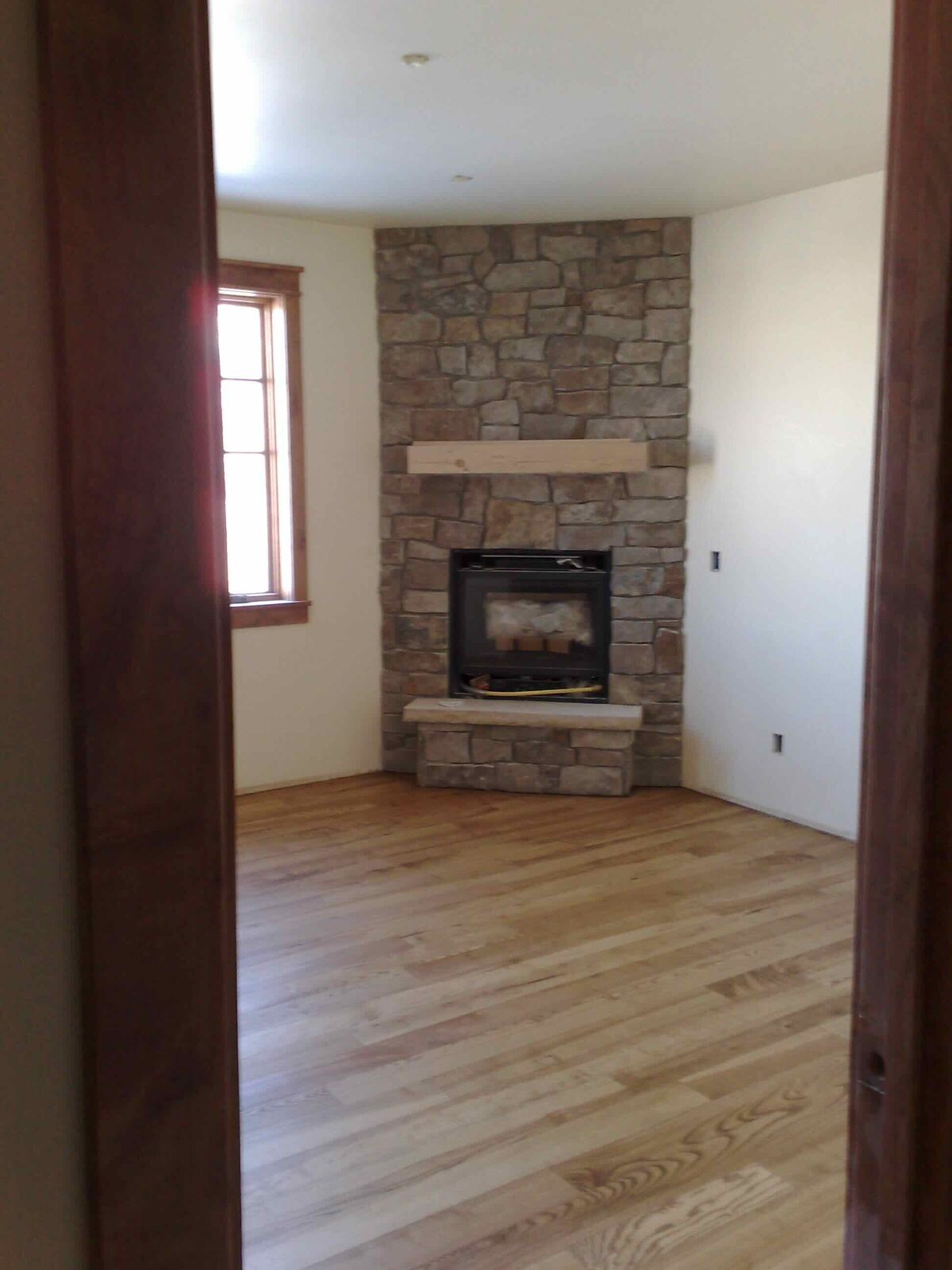 The finished great room and corner hearth.